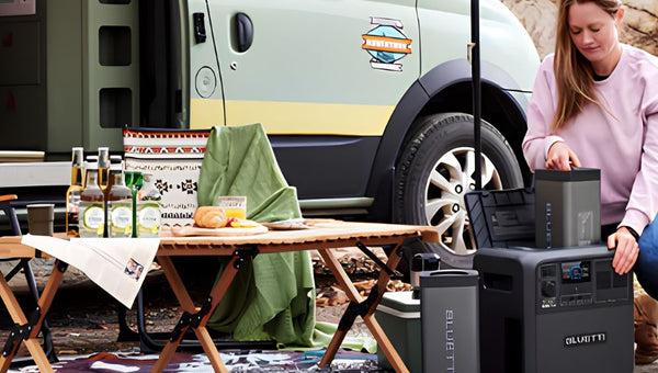 Woman using portable power stations beside a camper van.